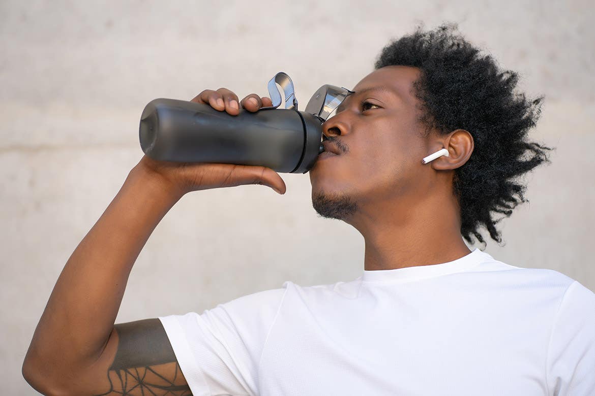 athletic man drinking water