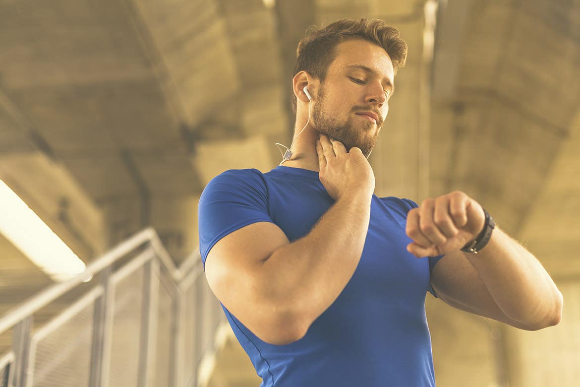 man measuring his pulse