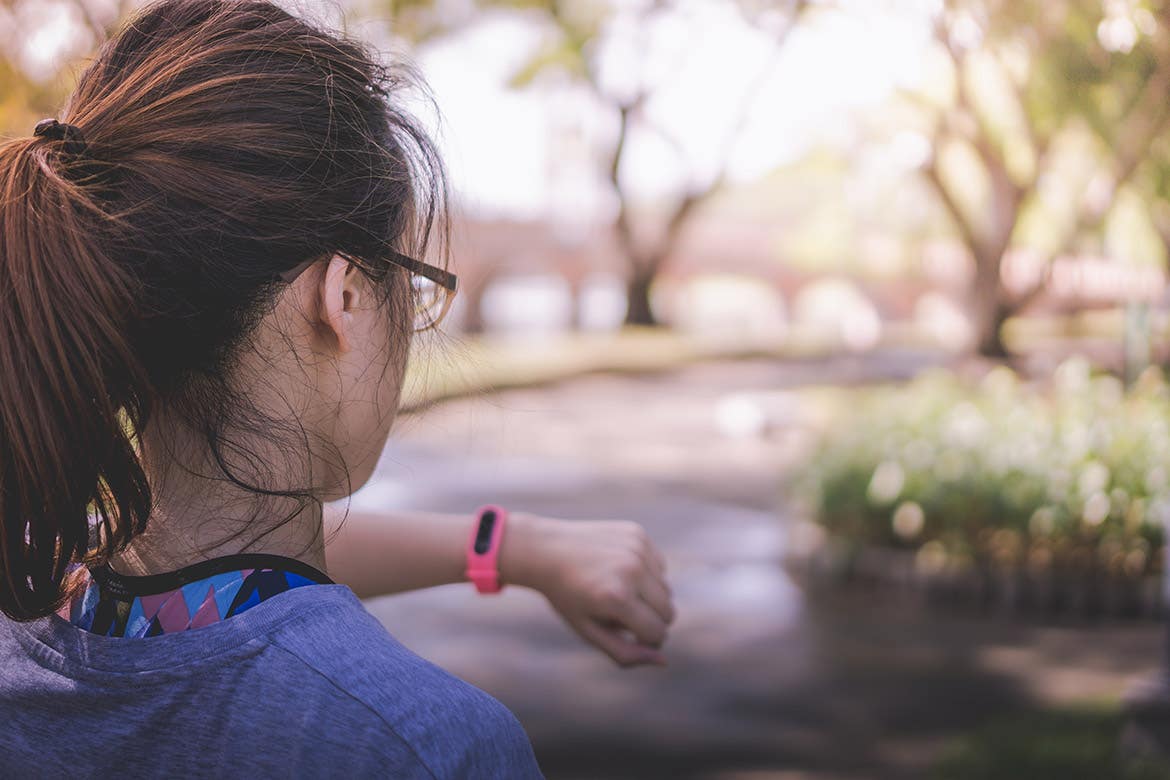 young woman checking her heart rate